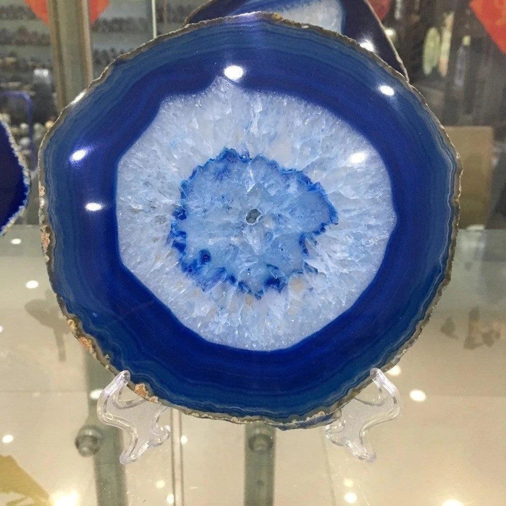 Blue agate geode plate with electric blue hues and circular pattern, resembling intricate mineral formations, ideal for luxury stone serving and home decor.