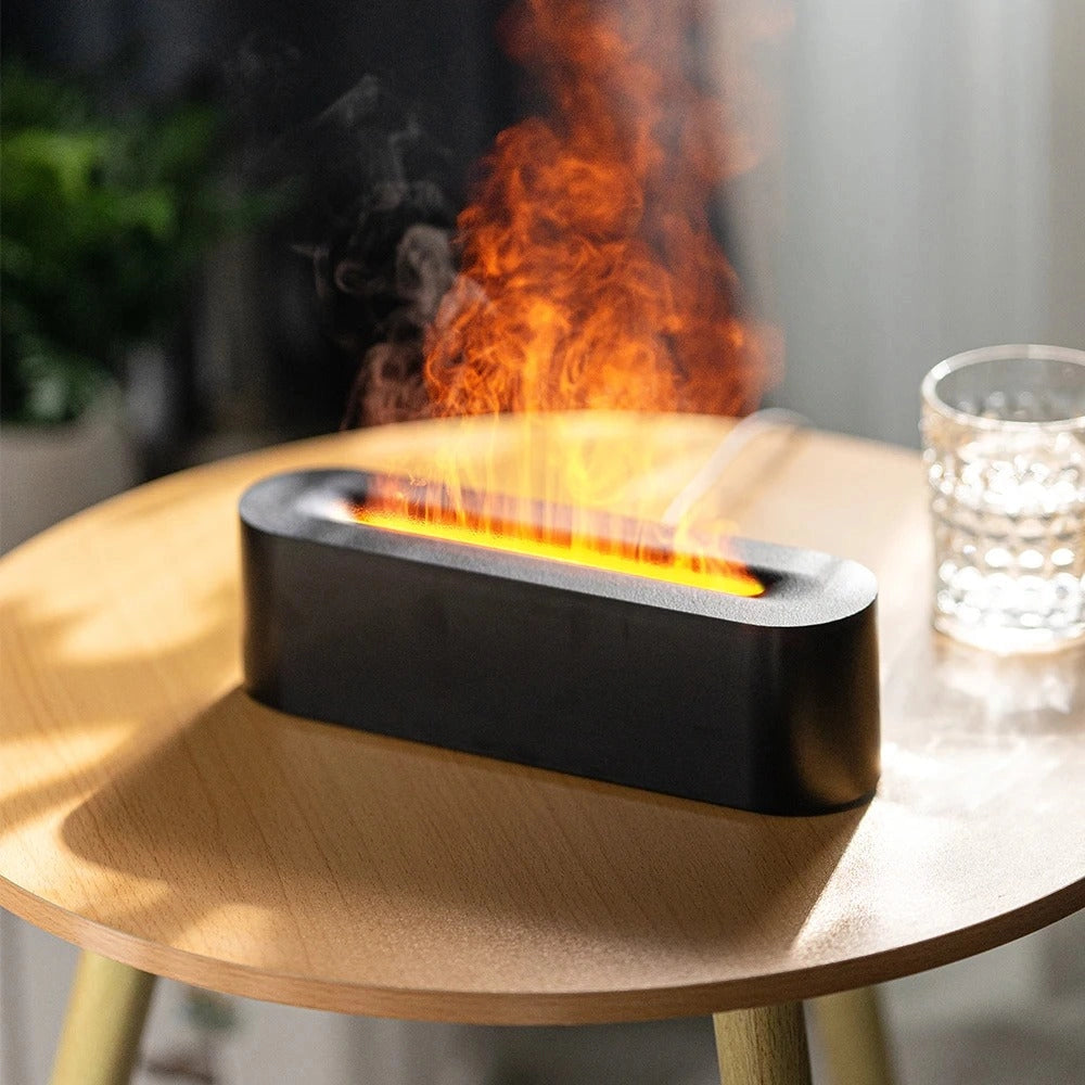 Portable ventless tabletop fire pit with a blue flame ethanol burner placed on a wooden rectangular coffee table, surrounded by outdoor furniture.