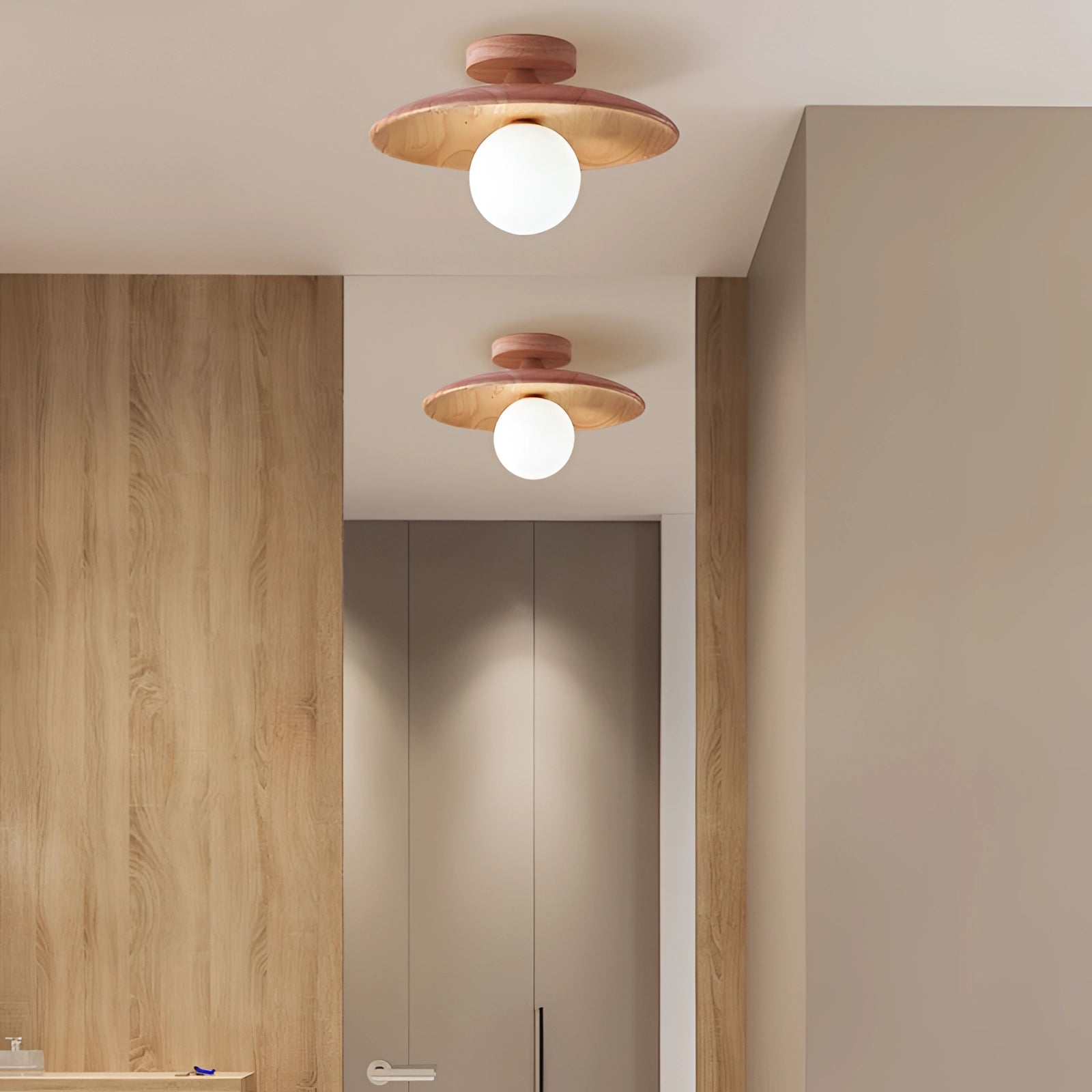 Bronze modern round flush mount ceiling light with a warm glow, featuring a sleek fixture and shaded design, installed on a wooden ceiling within a residential interior setting.