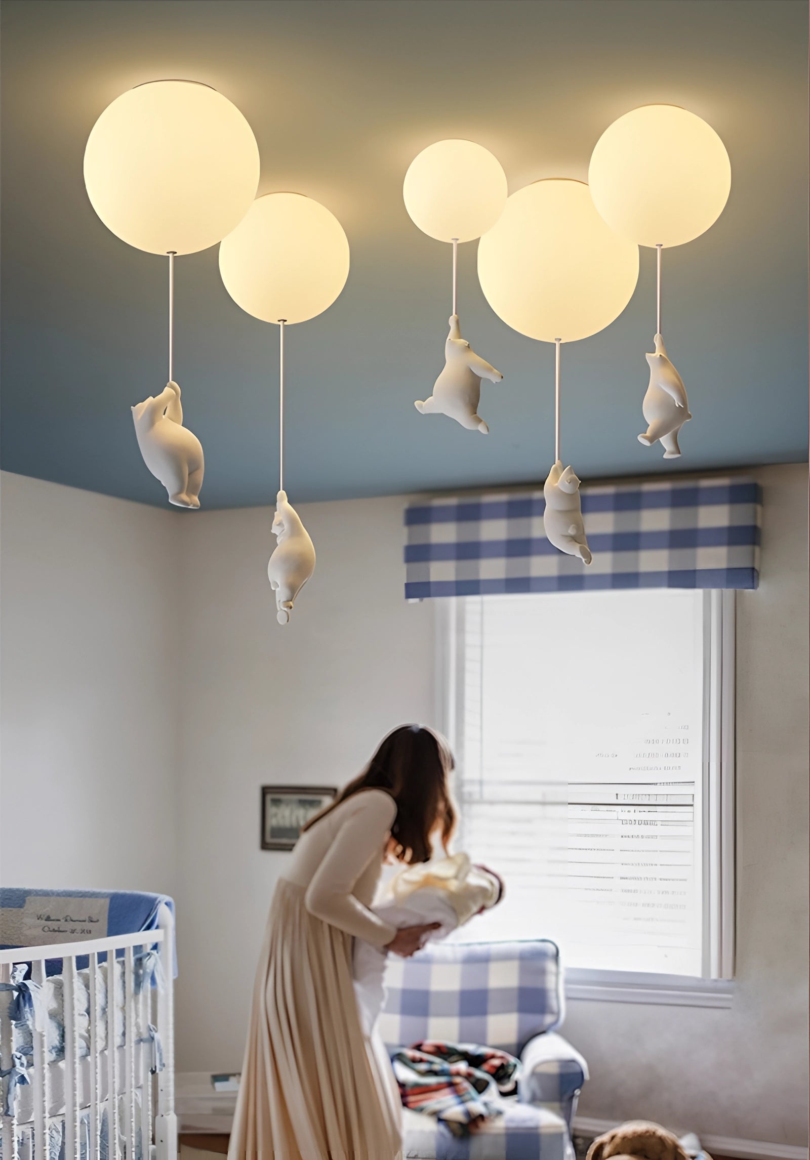 Cat pendant light hanging from the ceiling in a modern interior setting, featuring a minimalist design with grey and wood elements, positioned near a window.