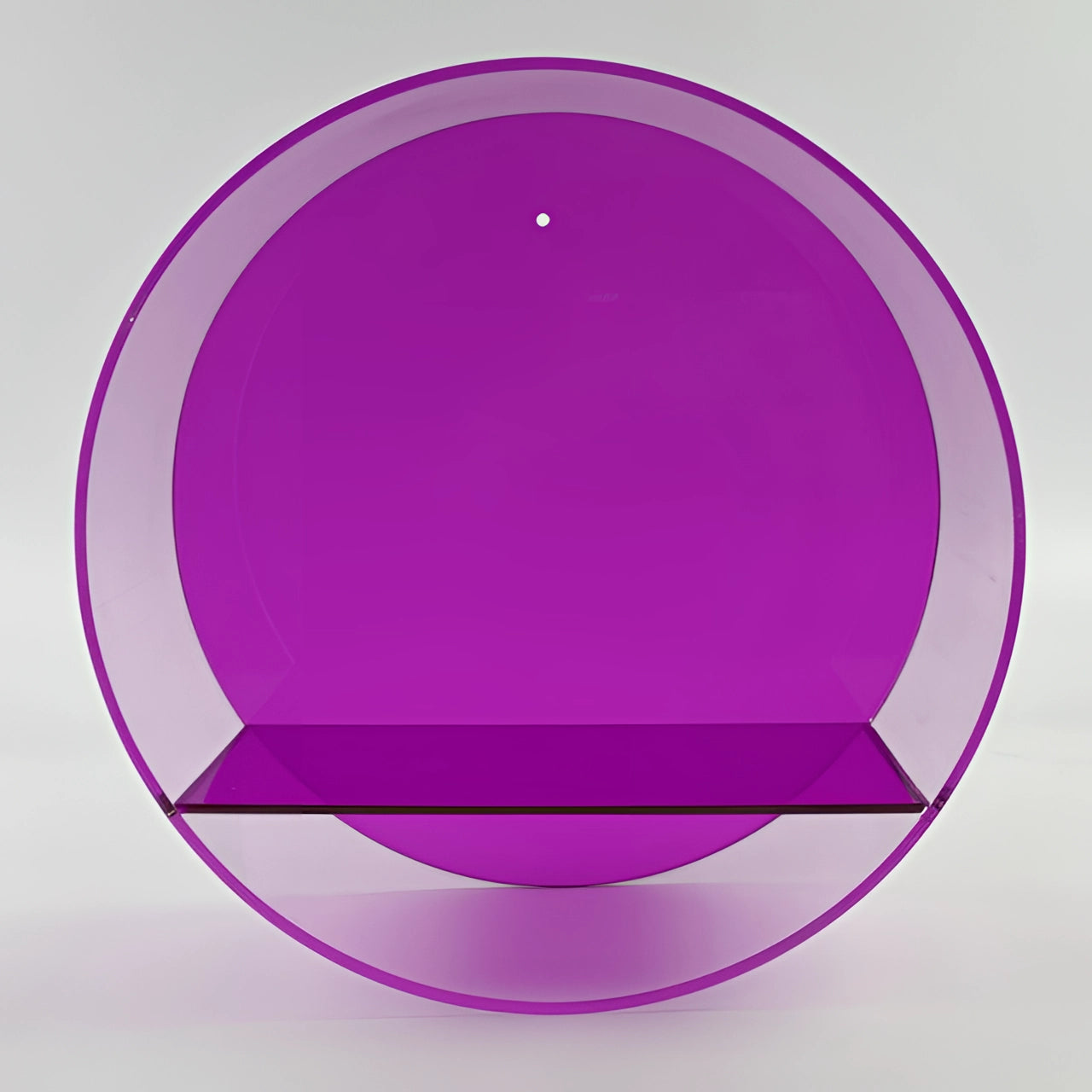 
A modern minimalist circular black glass floating shelf with a purple hue, displaying decorative dishware and a small plant.