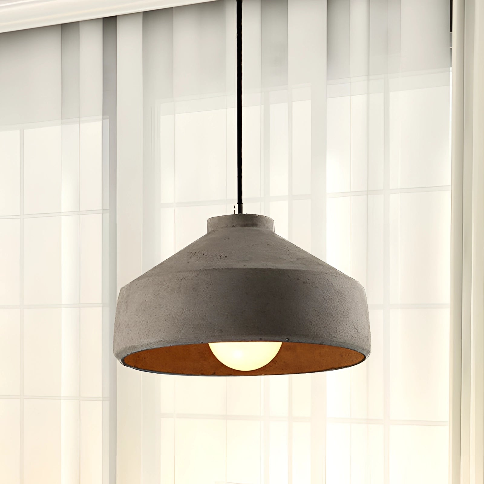 Concrete pendant light with an industrial minimalist design, featuring a grey rectangular shade that diffuses light softly, complemented by wooden accents.