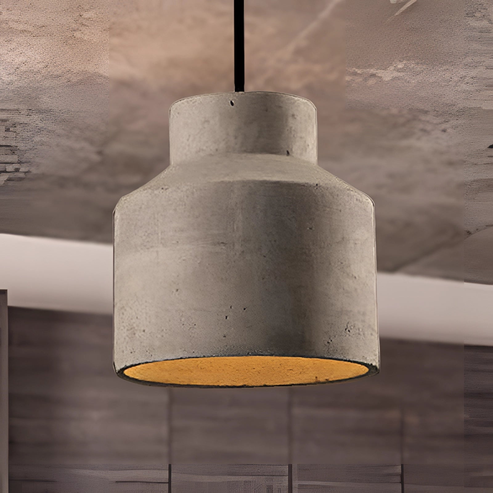 Concrete pendant light with a minimalist industrial design in grey, featuring a rectangular shape and suspended from the ceiling, showcasing a combination of concrete and metal materials.