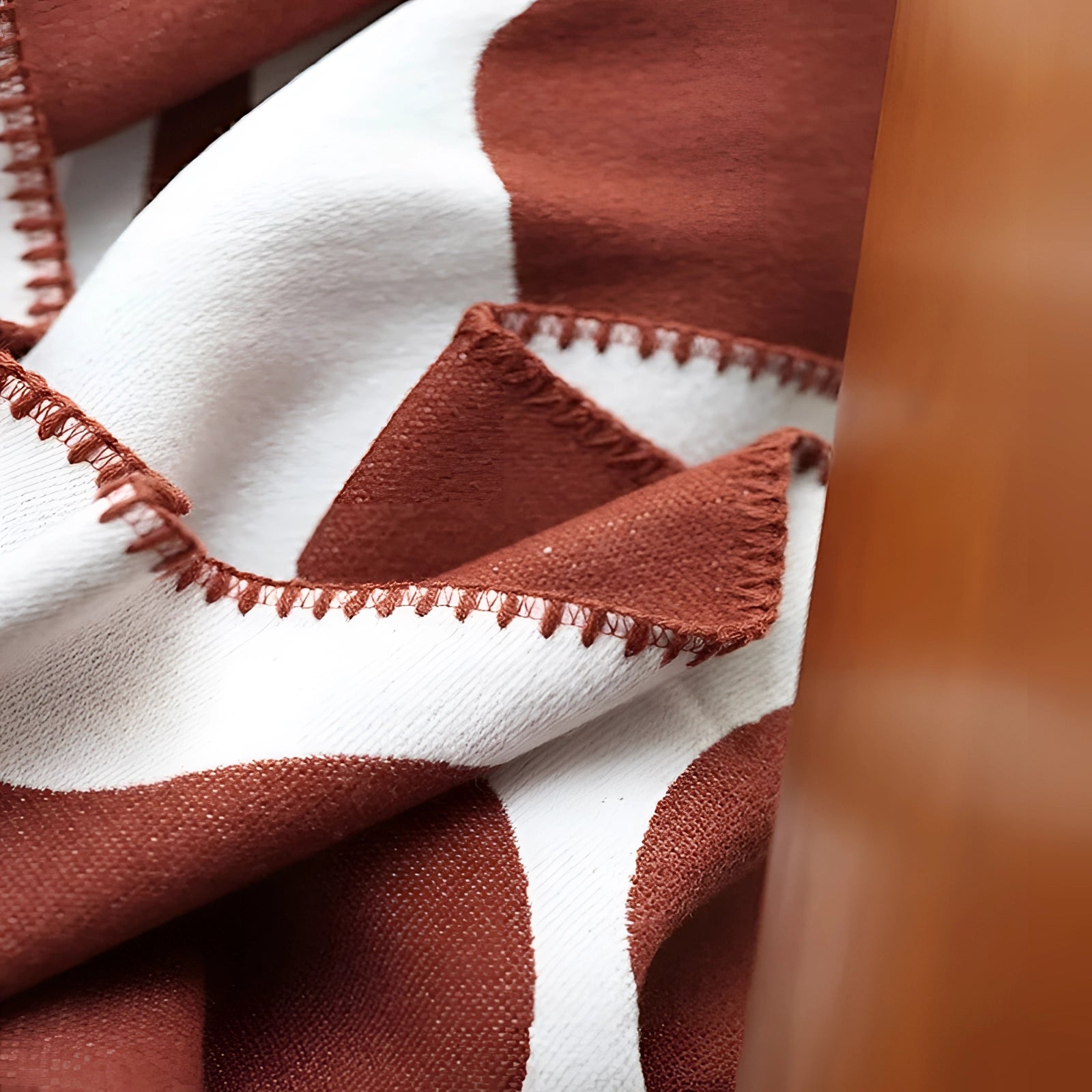 Brown and white cow print throw blanket made of soft fleece fabric, featuring a distinct animal pattern.