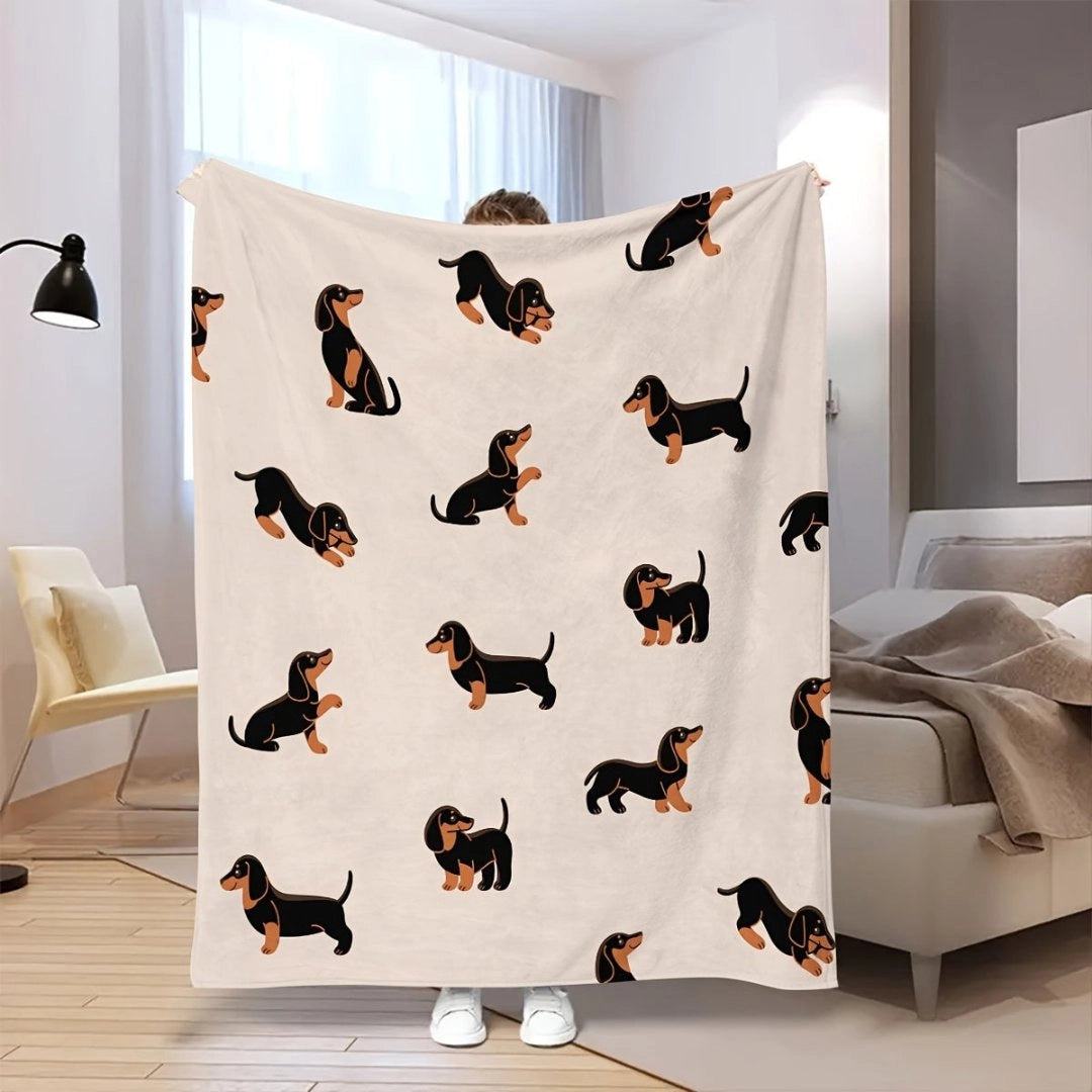 Cozy orange dachshund-themed fleece blanket draped over a wooden floor.