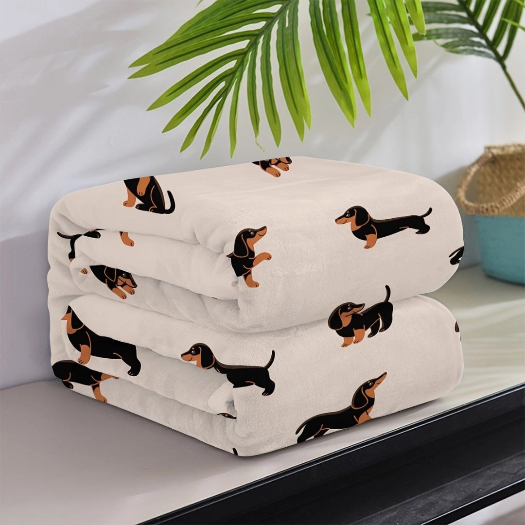 Dachshund-themed fleece blanket featuring a playful sausage dog design, ideal for pet lovers, displayed on a flat surface.