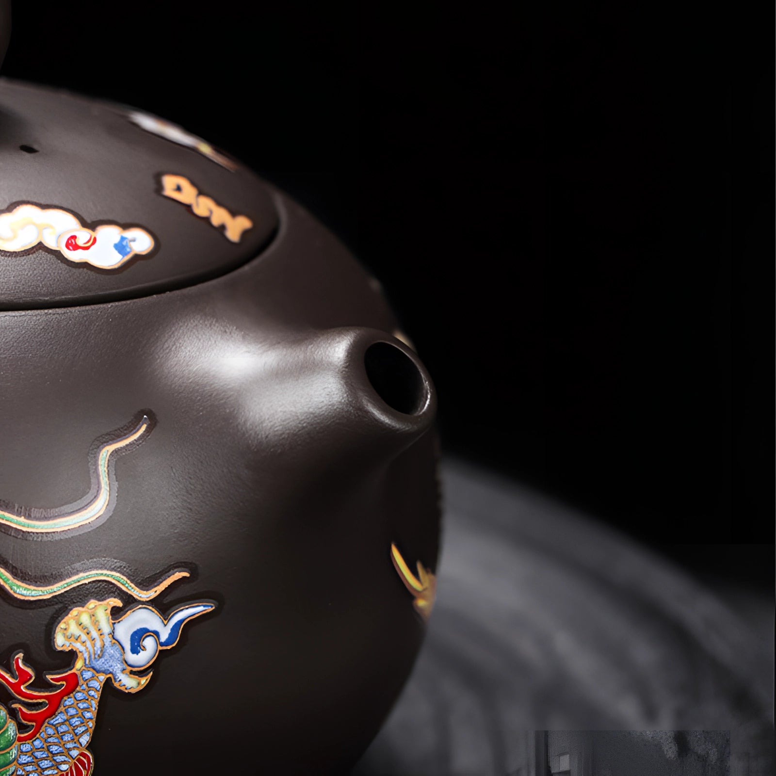 A hand-painted Chinese ceramic teapot with an intricate dragon design, featuring a heat-resistant build.