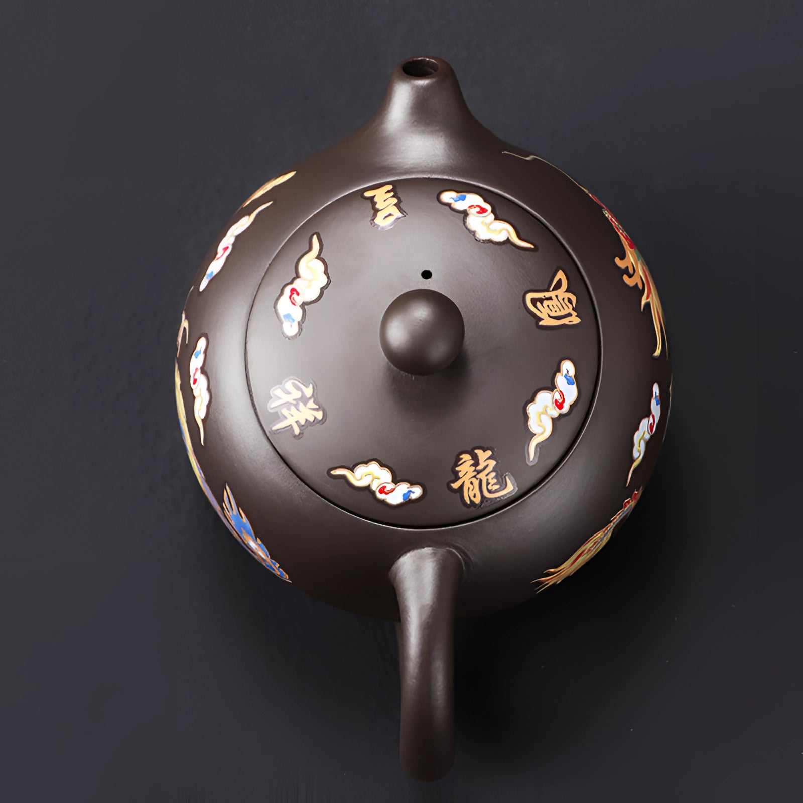 Hand-painted Chinese ceramic teapot with a dragon design, positioned elegantly, highlighting its intricate artistry and smooth, round shape.