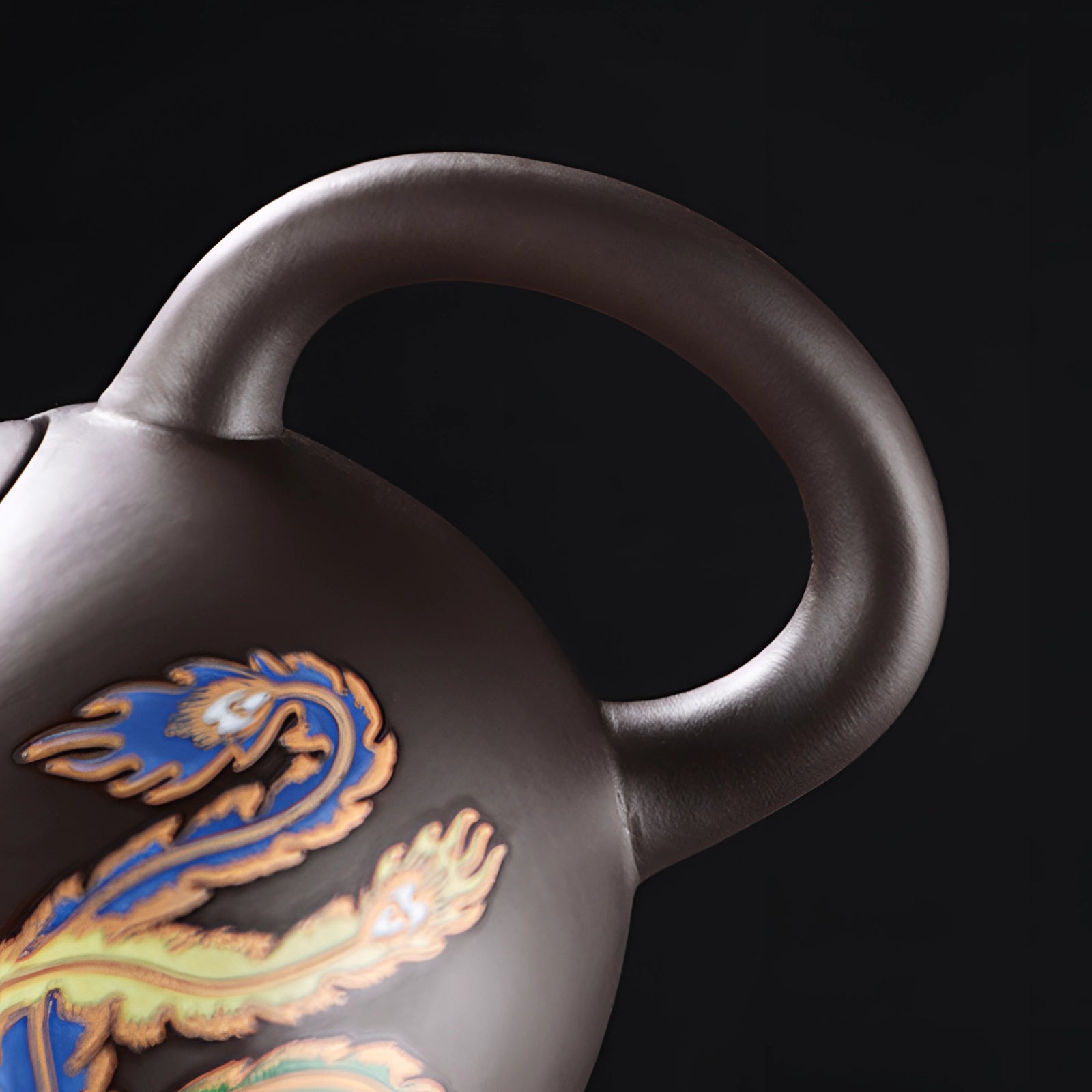 Hand-painted Chinese ceramic teapot with a dragon design, showcasing intricate details and a heat-resistant build, ideal for serving tea.