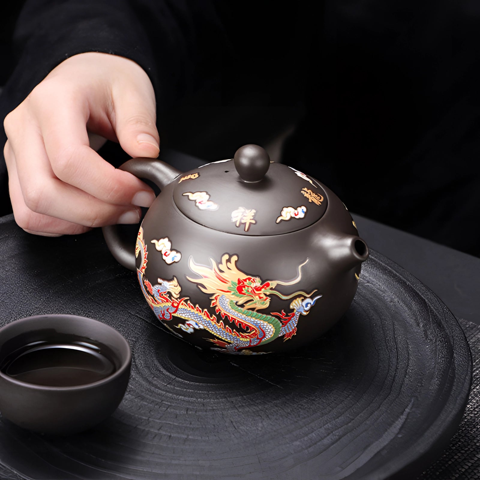 Hand-painted Chinese ceramic teapot with a dragon design, featuring a heat-resistant structure and elegant porcelain finish.