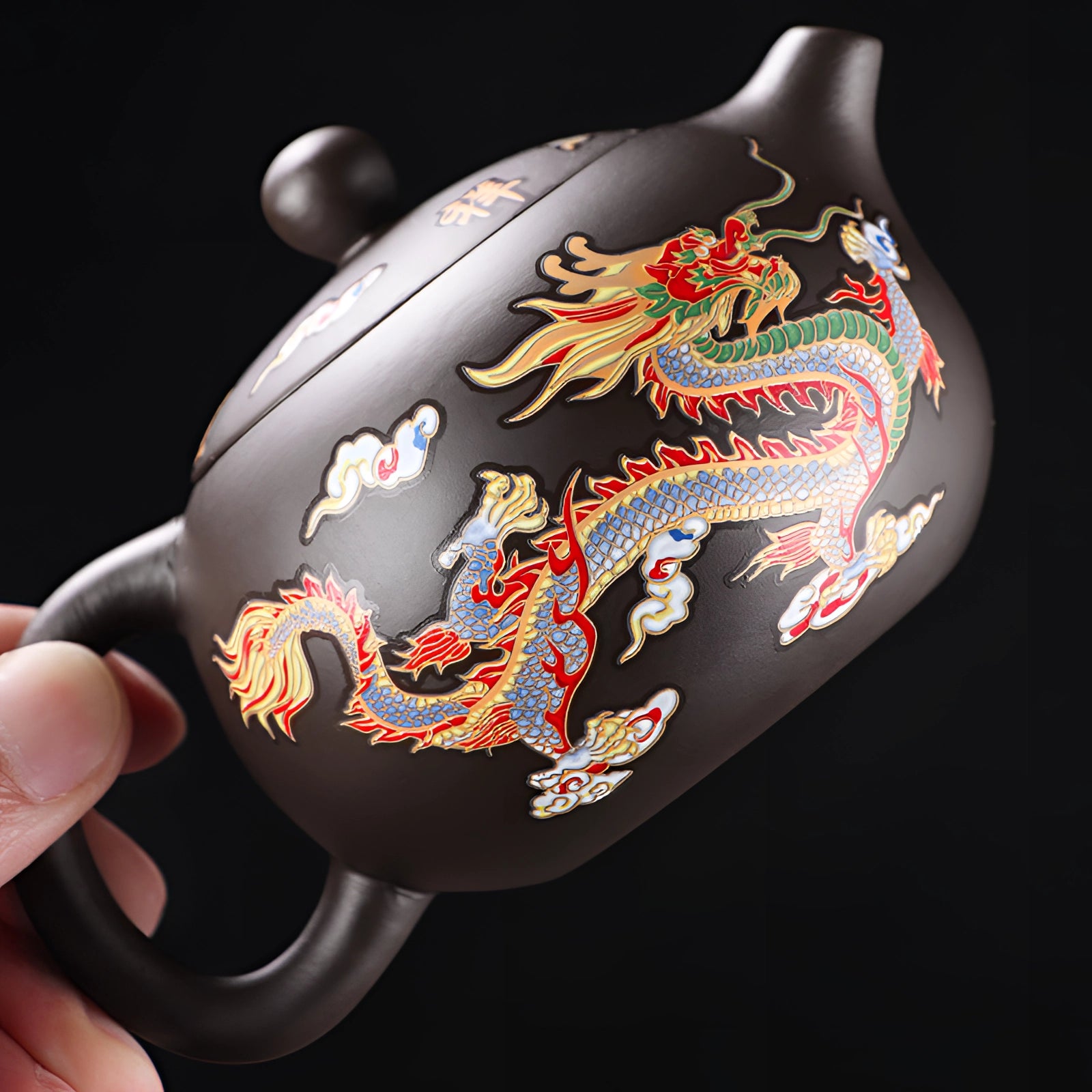 A hand-painted Chinese ceramic teapot featuring an intricate dragon design, crafted to be heat-resistant.