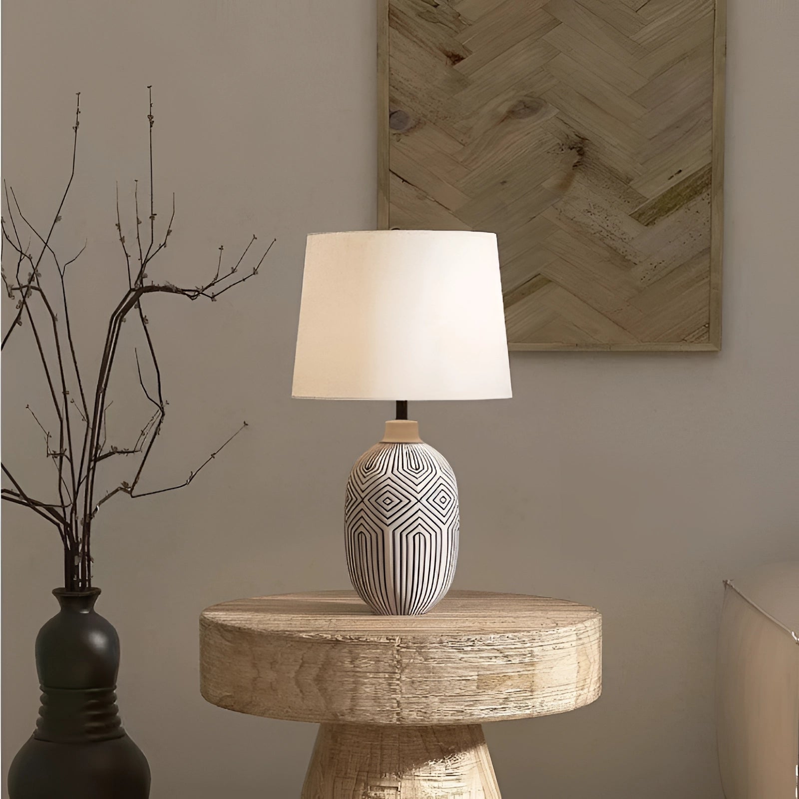 Elegant geometric ceramic lamp with modern design, placed on a wooden surface, emitting a soft light, enhancing the interior decor.