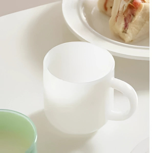 Elegant jade frosted glass mug in white, showcasing a modern minimalist design, suitable for serving coffee or tea.