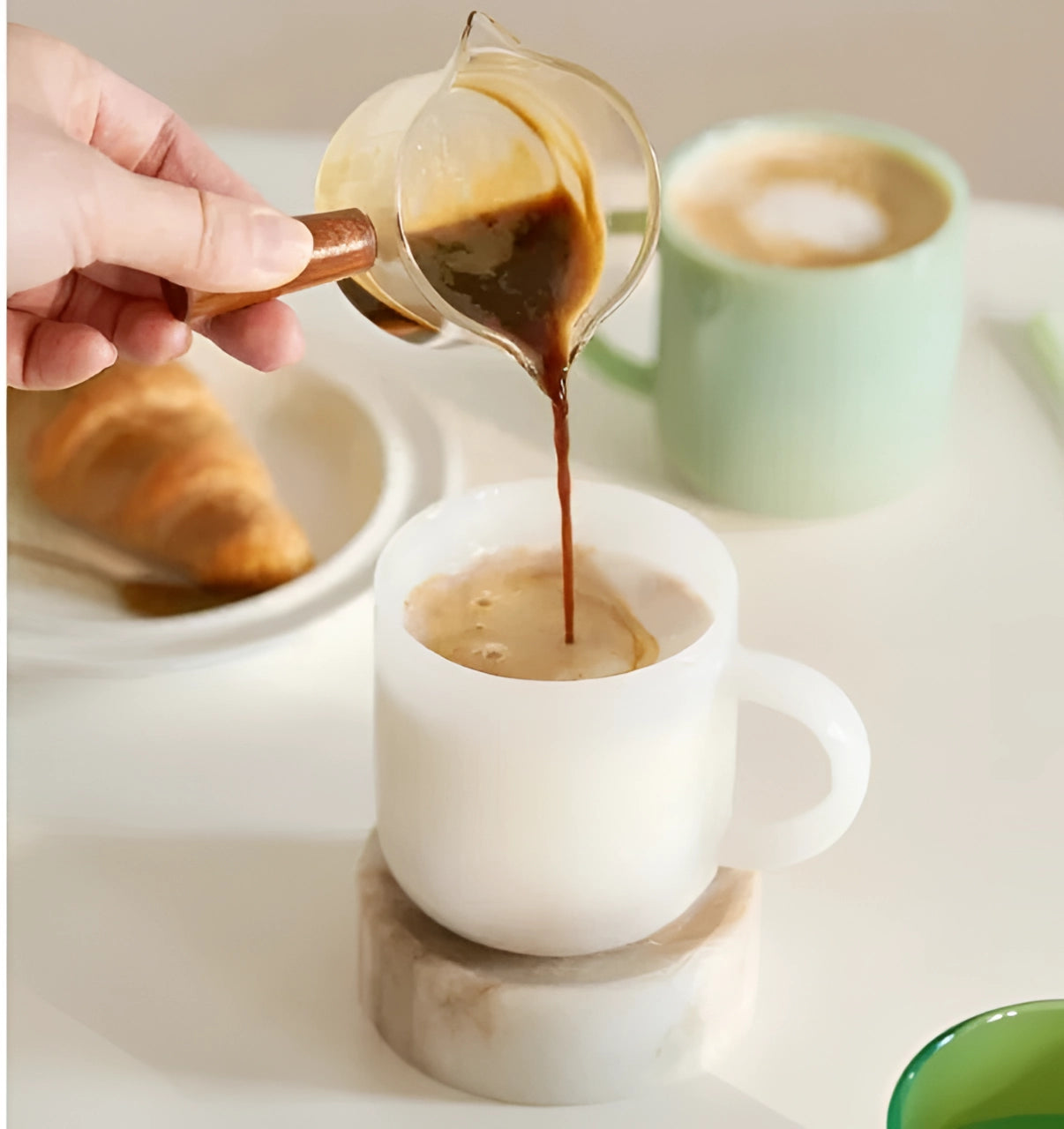 Elegant jade frosted glass mug with a minimalist design, suitable for serving coffee or other beverages, showcased on a table setting.