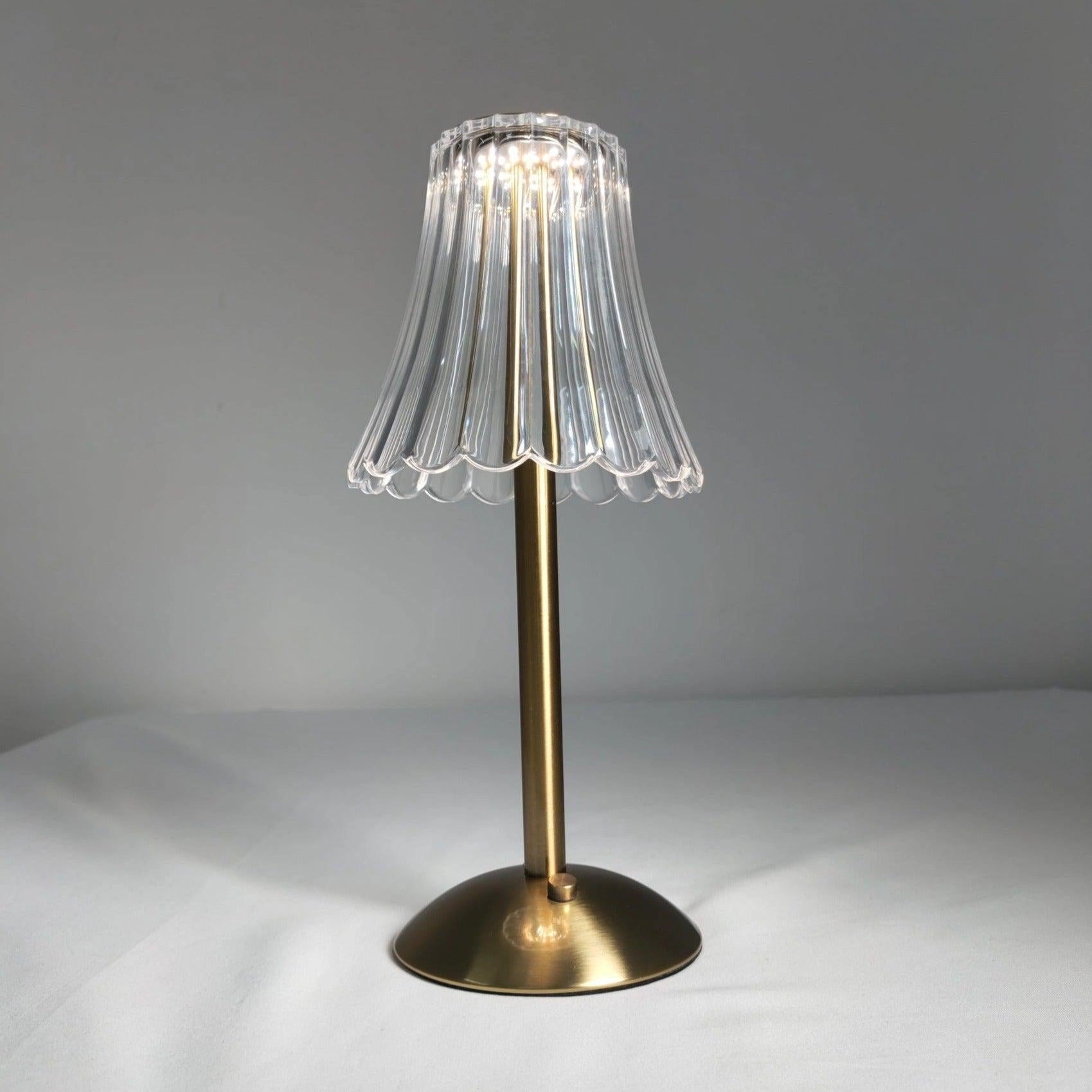 Elegant pleated table lamp with an acrylic lampshade, modern gold base, and LED light, featuring a stylish design that combines natural wood and metal elements.