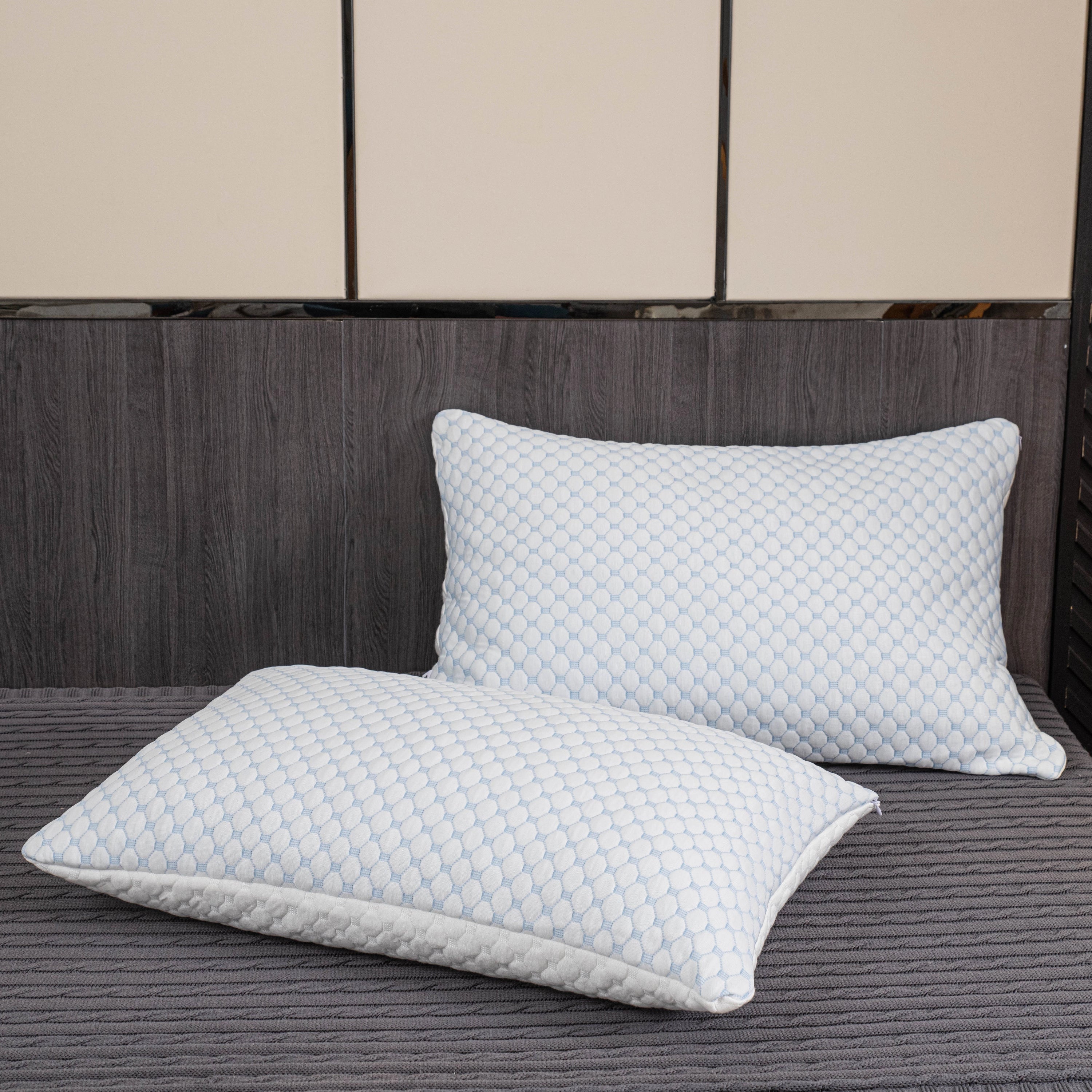 Ergonomic cooling memory foam pillow with a rectangular shape, designed for luxury hypoallergenic comfort, placed on a wooden floor within a stylish interior setting.