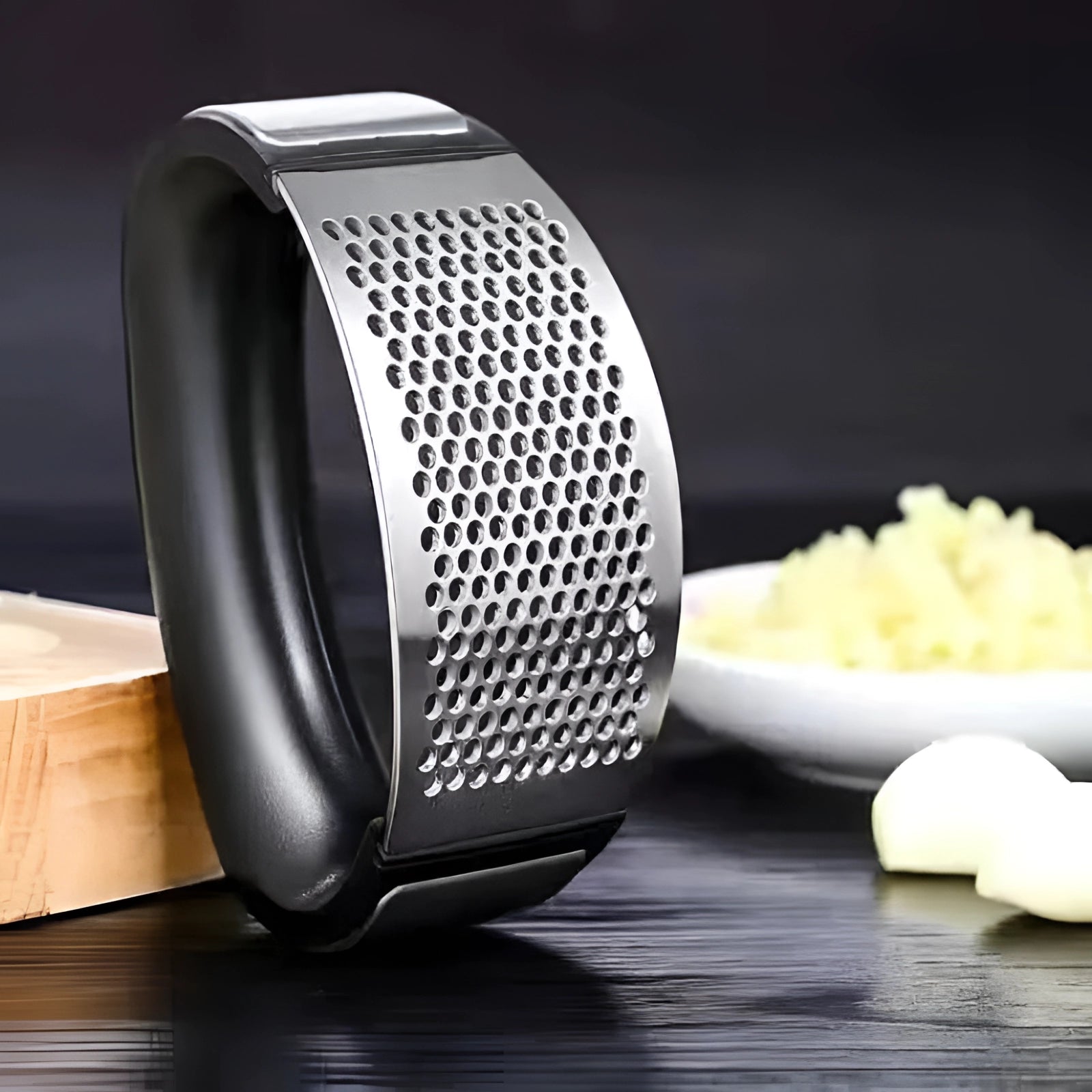 Ergonomic stainless steel garlic press with an easy squeeze handle and rust-proof design.