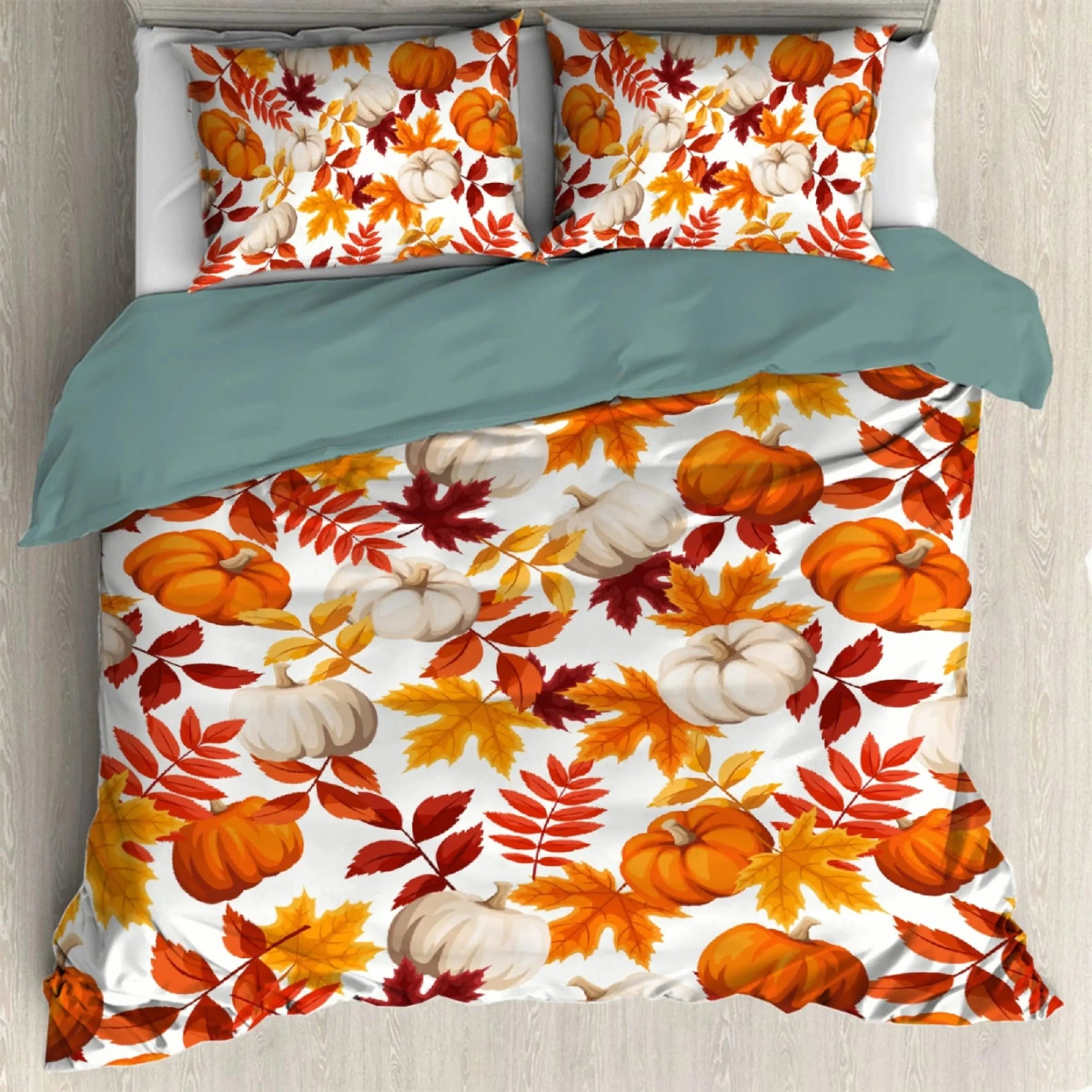 Orange autumn leaf duvet cover with pumpkin and leaf patterns, featuring vibrant fall colors, laid out on a bed in a cozy interior setting.