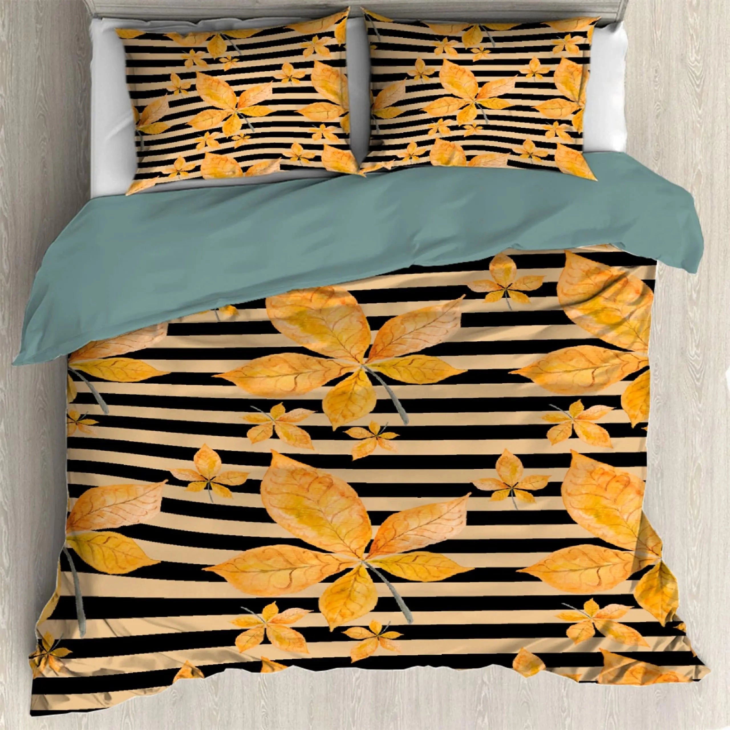 Autumn-themed duvet cover featuring an orange and pumpkin leaf pattern, accompanied by matching pillowcases, displayed on a bed.