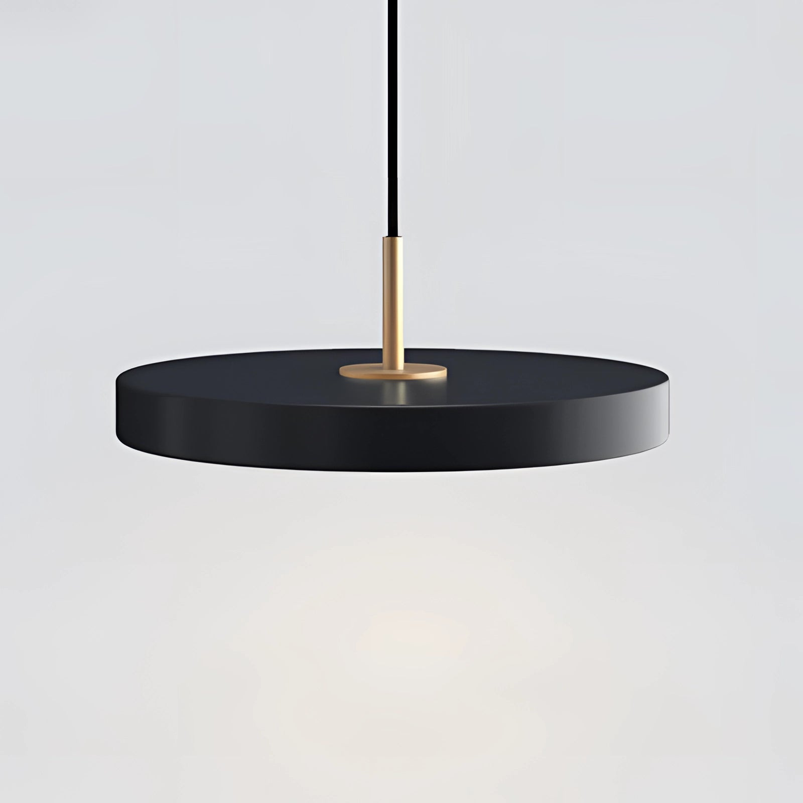 Modern minimalist black floating dining table with a cold white surface, accompanied by a sleek black ceiling light fixture, enhancing the contemporary interior design with a balanced and stylish aesthetic.