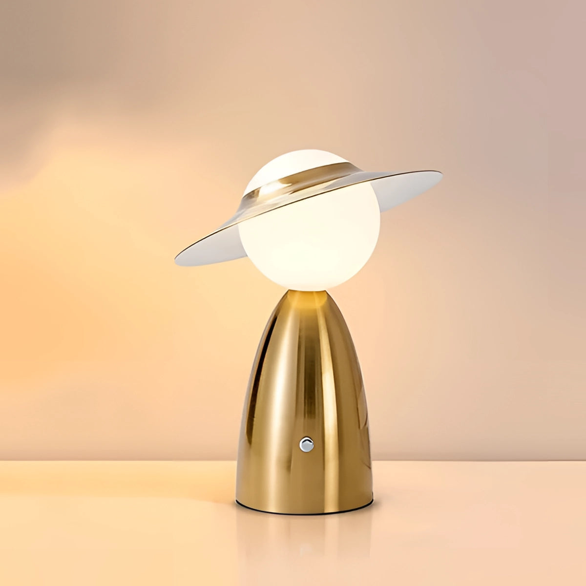 Futuristic gold satellite table lamp with a unique modern design, featuring a spherical metal shade and sleek base, ideal as a bedside light.