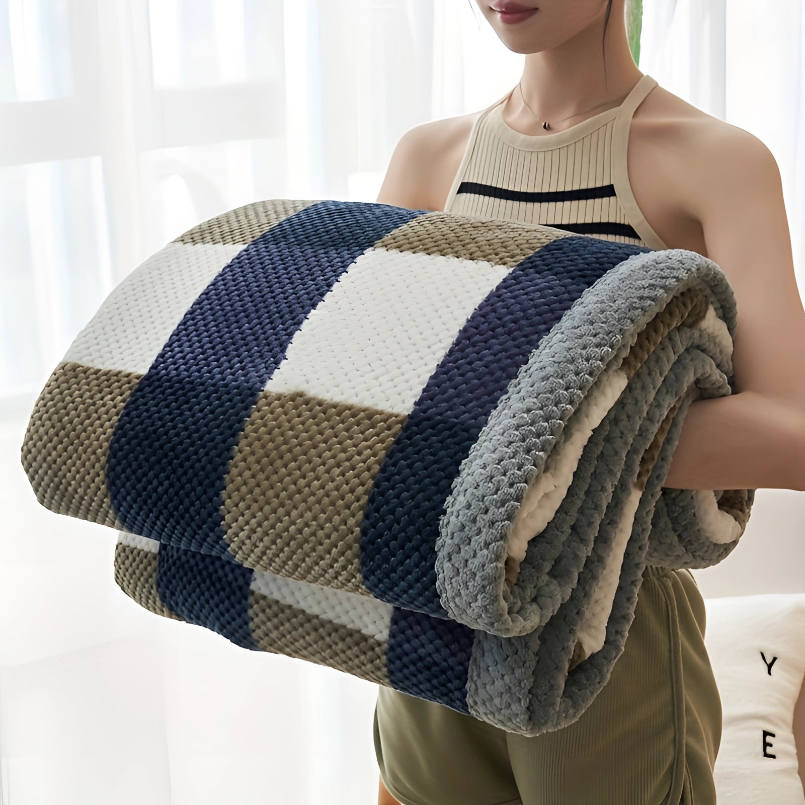 Oversized geometric black and white quilt blanket displayed on a bed, showcasing its hypoallergenic fabric and intricate design.