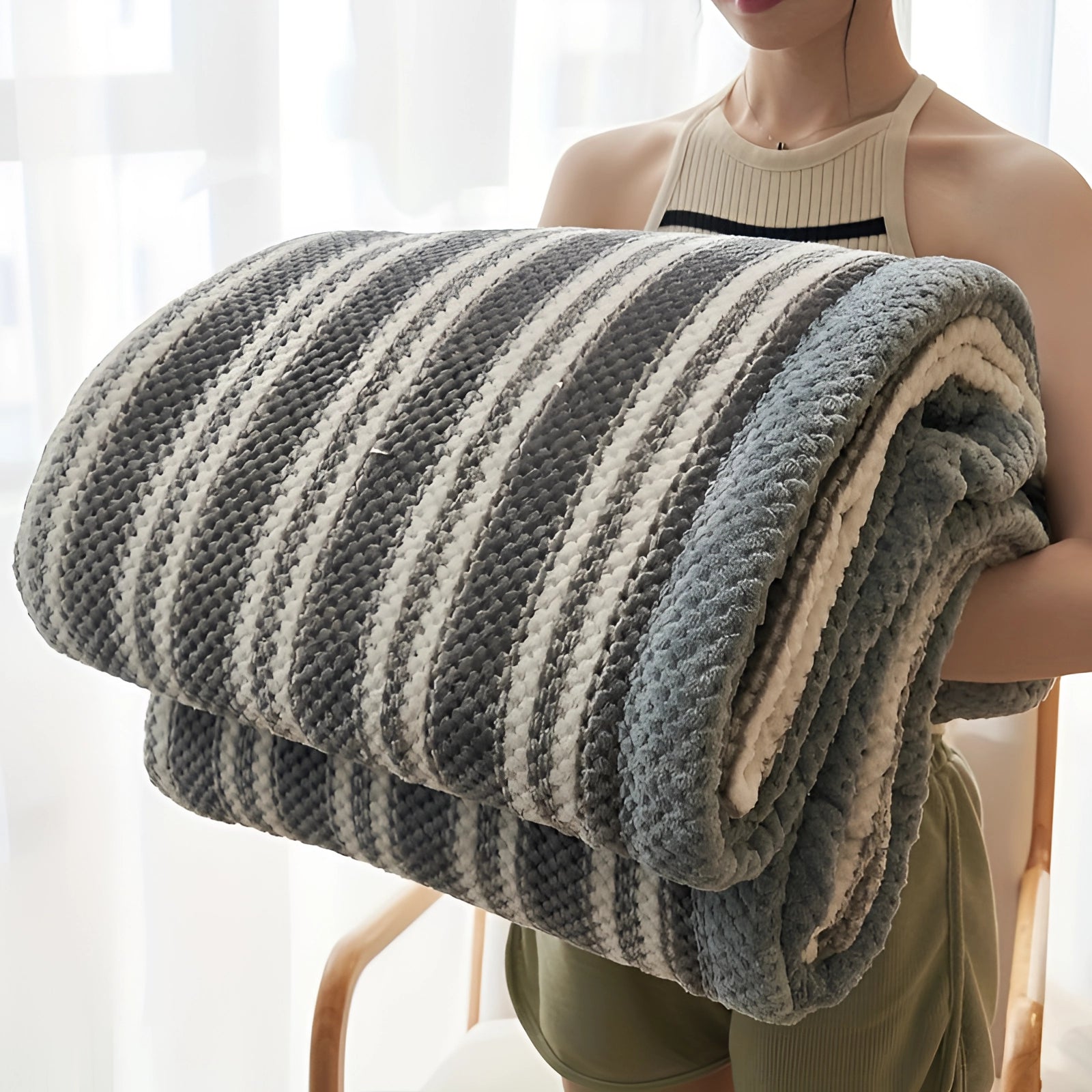 Geometric black and white oversized quilt blanket displayed on a bed, featuring a bold geometric pattern with contrasting colors in a hypoallergenic fabric.