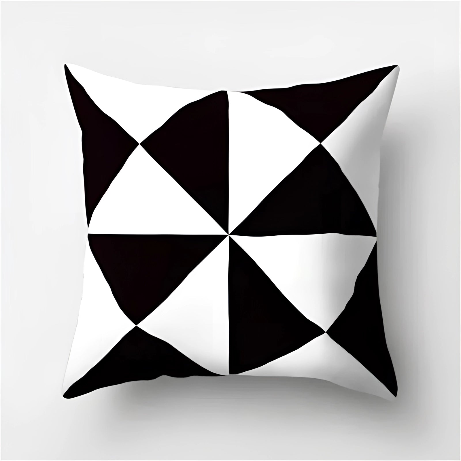 Geometric black and white pillow with modern abstract design featuring symmetrical patterns of triangles and circles, crafted from natural materials; size 60 x 60 cm.