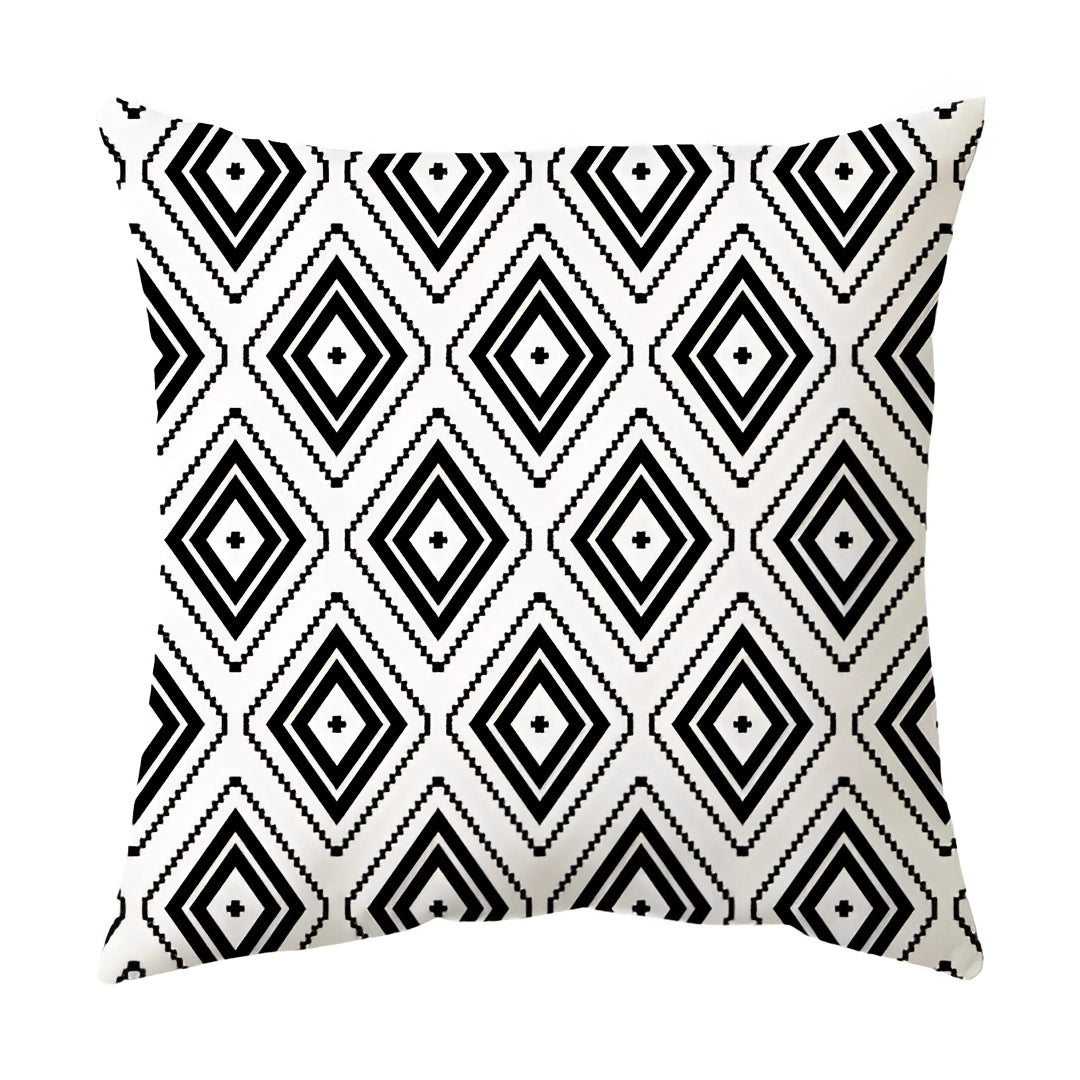 Black and white geometric pillow featuring an abstract pattern with symmetrical motifs, designed in a modern style. The pillow is square-shaped, measuring 60 x 60 cm, and showcases a visually striking monochrome theme.