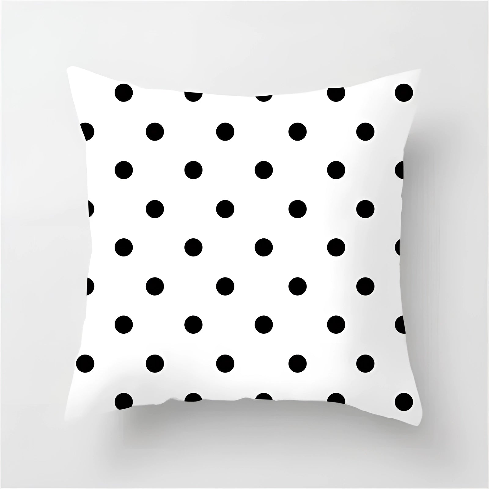 Geometric black and white pillow featuring modern abstract patterns with symmetrical designs, suitable for contemporary home decor.