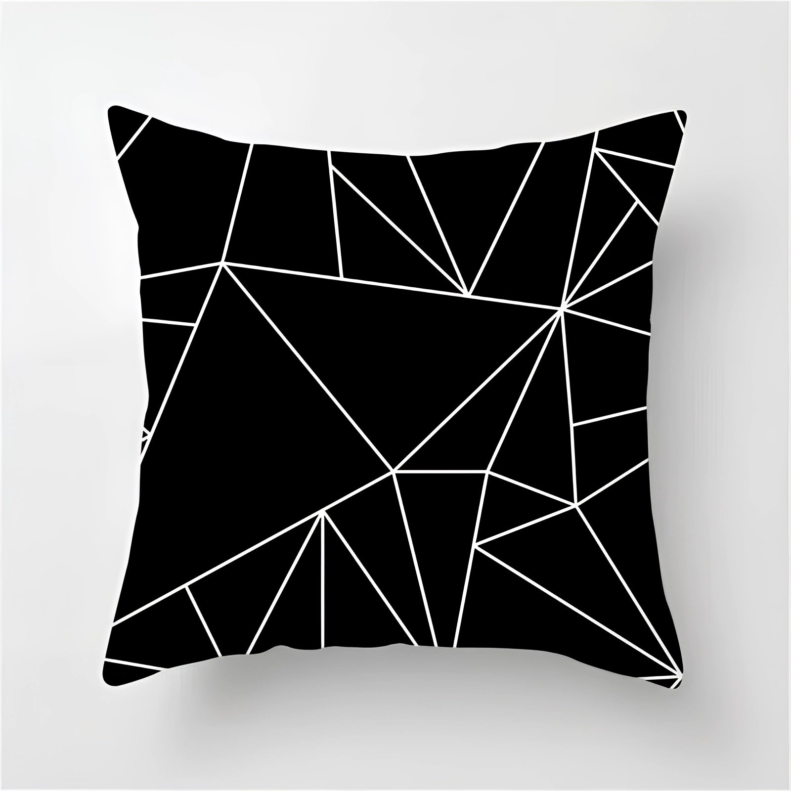 Geometric black and white pillow featuring an abstract pattern with rectangles, triangles, and circles, designed for modern decor. The cushion measures 60 x 60 cm and showcases symmetry and creative arts elements in a striking monochrome color scheme.