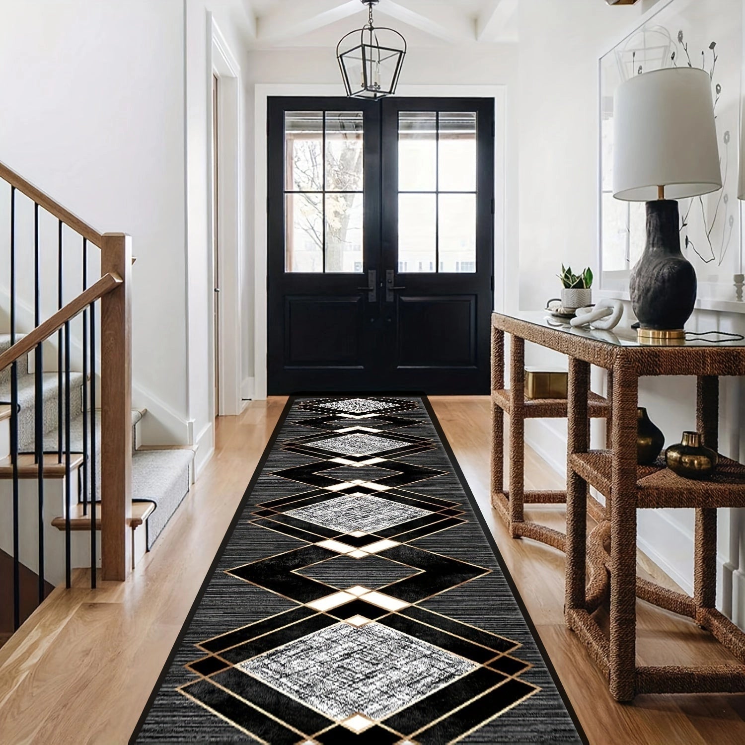 Black and white geometric diamond-patterned hallway runner placed on wooden flooring in a well-lit interior space.