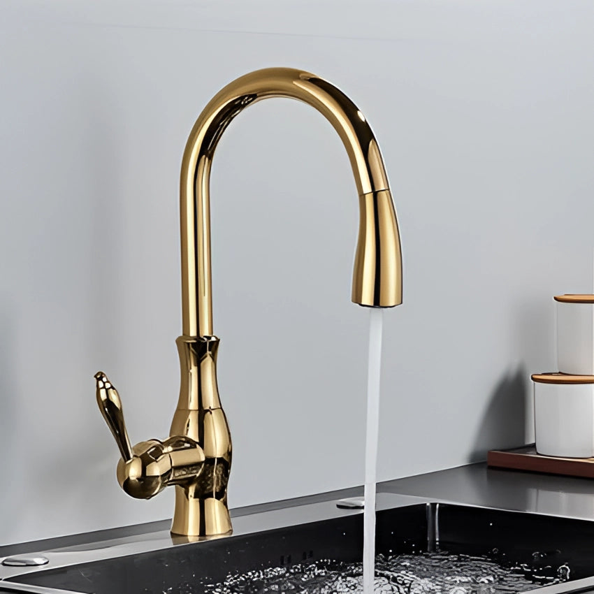 
A modern gold brass kitchen faucet with a high-arc and pull-down spray design, installed over a sink, showcasing its elegant and functional plumbing fixture.