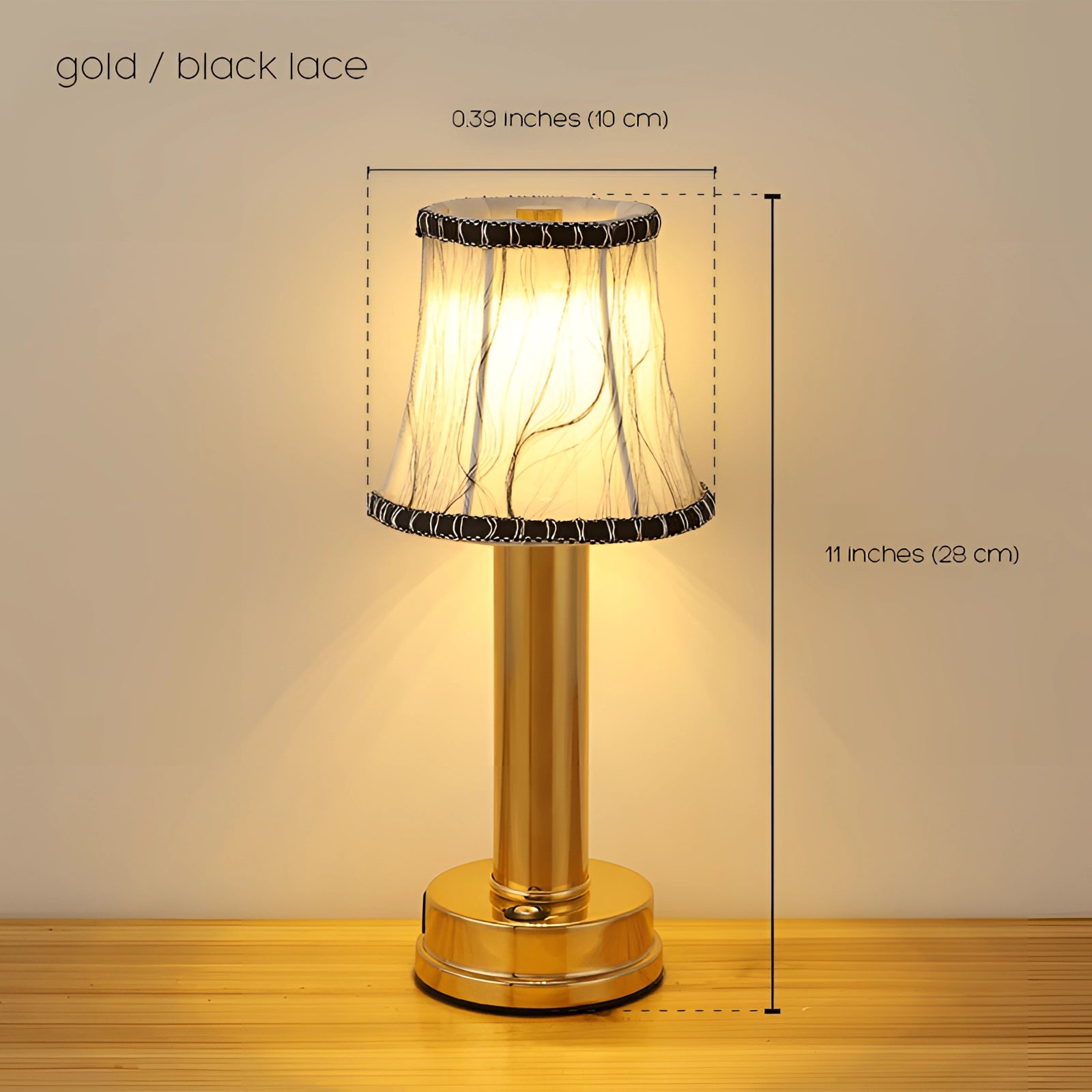 Gold and brass luxury designer table lamp with a matt gold finish and a white tip, featuring an elegant and modern design suitable for bedside lighting; the lamp includes a stylish lampshade and complements various interior decors.