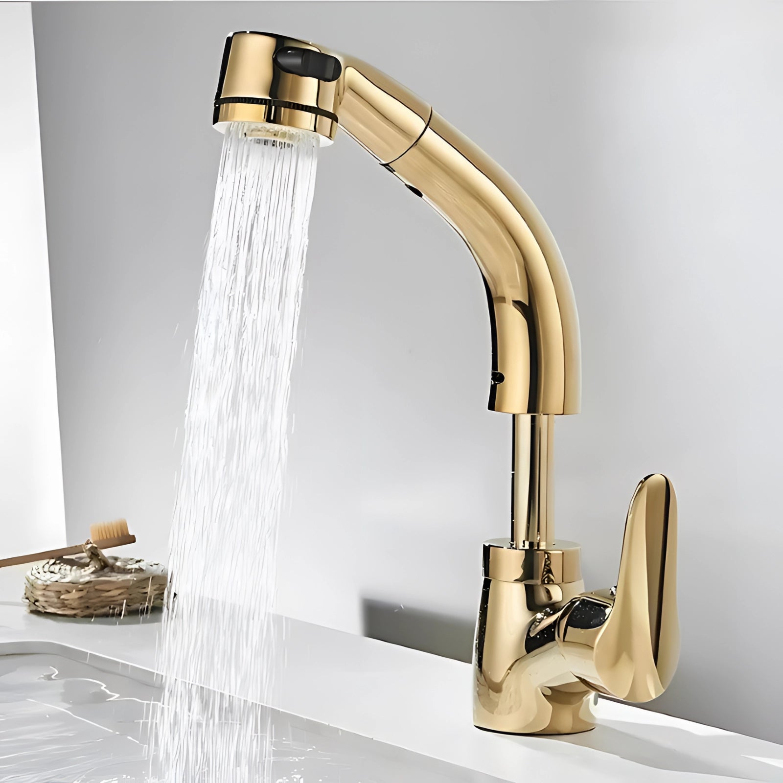 Elegant gold kitchen faucet with a pull-out sprayer, featuring a modern luxury design, installed over a kitchen sink.