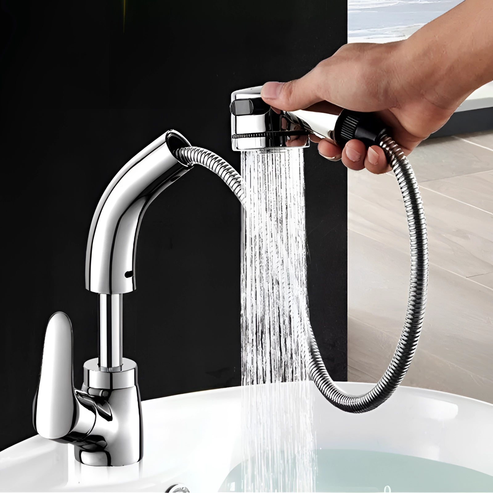 Modern gold kitchen faucet with a pull-out sprayer, elegantly designed for luxury, shown being used with water flowing into a sink, with a hand operating the faucet lever.