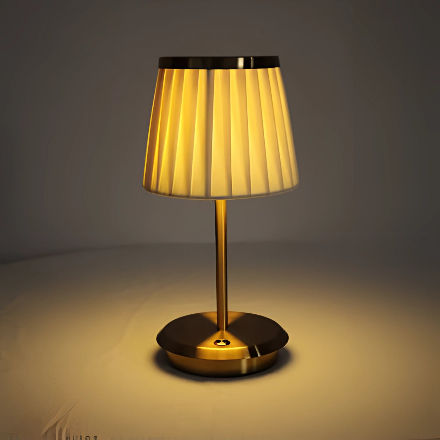 Elegant gold table lamp with a pleated shade, featuring a stylish rectangular base with wooden accents, perfect for adding luxury to any desk or table setting.