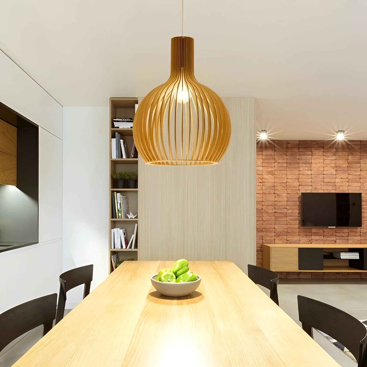 Golden wooden pendant light hanging in a modern dining room, featuring sleek wooden finish. The fixture is illuminated, showcasing its elegant design. The room includes a wooden table and minimalist interior decor elements.