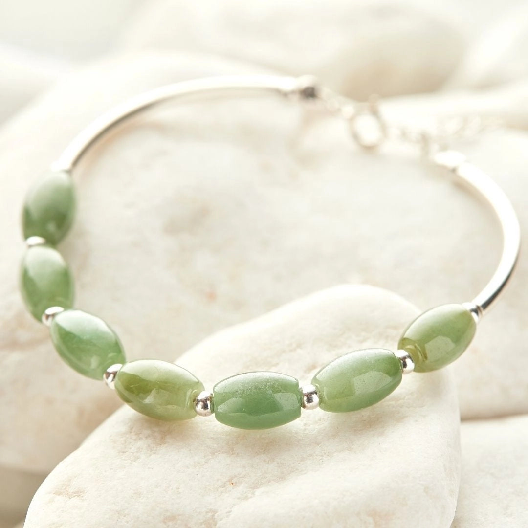 Green jade silver bracelet featuring natural oval stones, showcasing elegant craftsmanship and artistic design in fine jewelry.