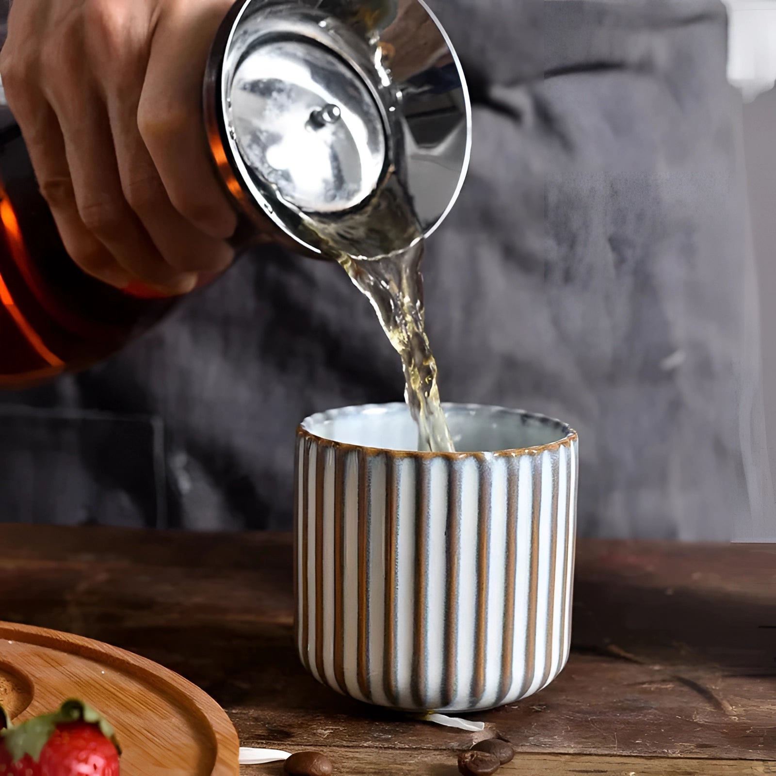 Handmade artisan green ribbed ceramic mug on a table, showcasing its unique stoneware texture and design.