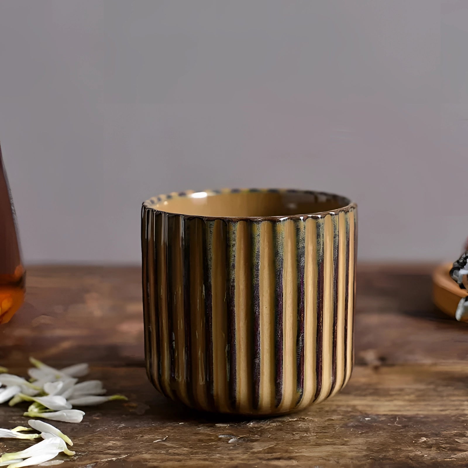 Handmade green ribbed ceramic mug, Design B, with a 180ml capacity, placed on a wooden table.