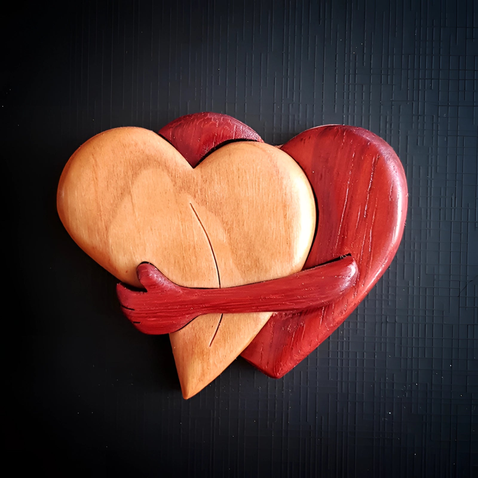 Handcrafted wooden heart puzzle featuring intricate pieces, made from high-quality hardwood with a warm peach and carmine finish, symbolizing love; perfect as a romantic gift or unique ornament.