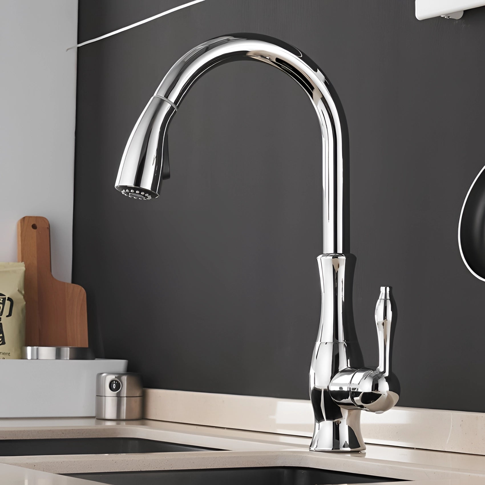 High-arc brushed nickel pull-down kitchen faucet with a sleek chromium finish, set against a light-colored kitchen interior.