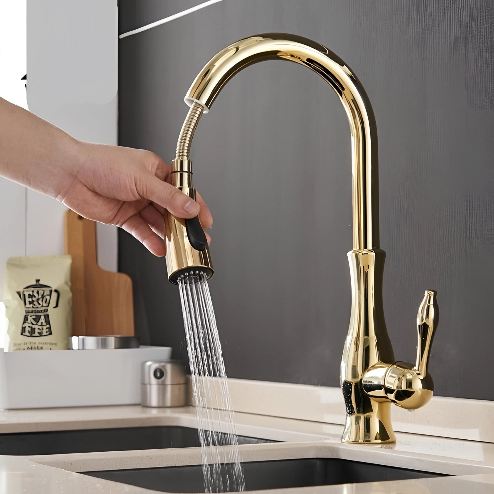 A brushed nickel high-arc stainless steel pull-down kitchen faucet installed over a sink, with a hand operating the tap, demonstrating water flow.