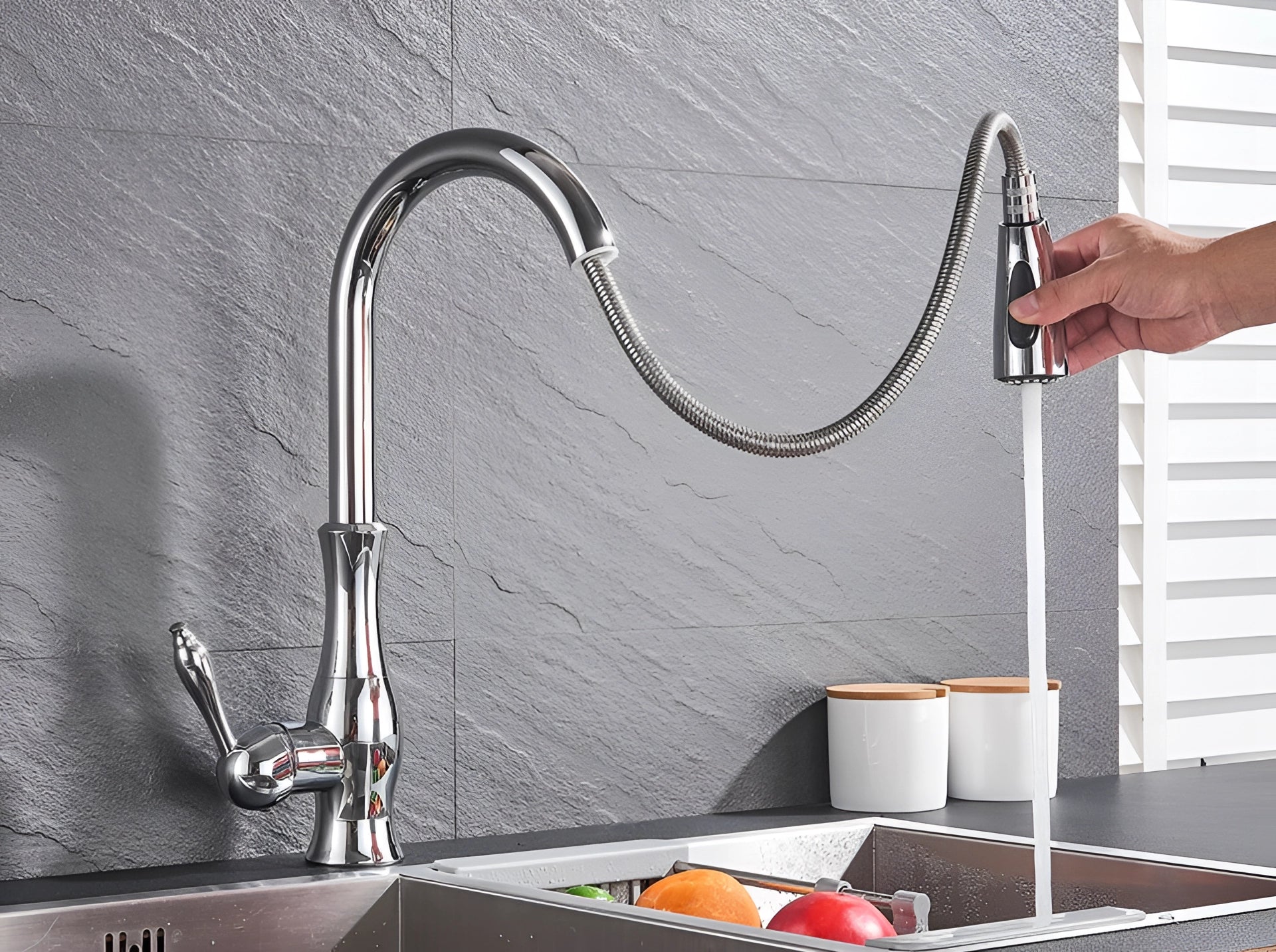 A brushed nickel high-arc stainless steel pull-down kitchen faucet with a sleek design, positioned on a wooden surface.