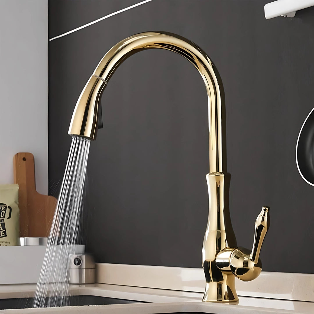 High-arc stainless steel pull-down kitchen faucet with a modern design, featuring a sleek gold finish, installed over a kitchen sink.