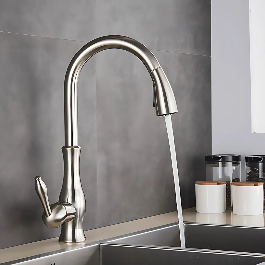 Sleek high-arc stainless steel pull-down kitchen faucet with a modern design installed on a rectangular sink, showcasing its functionality and contemporary style in an interior kitchen setting.