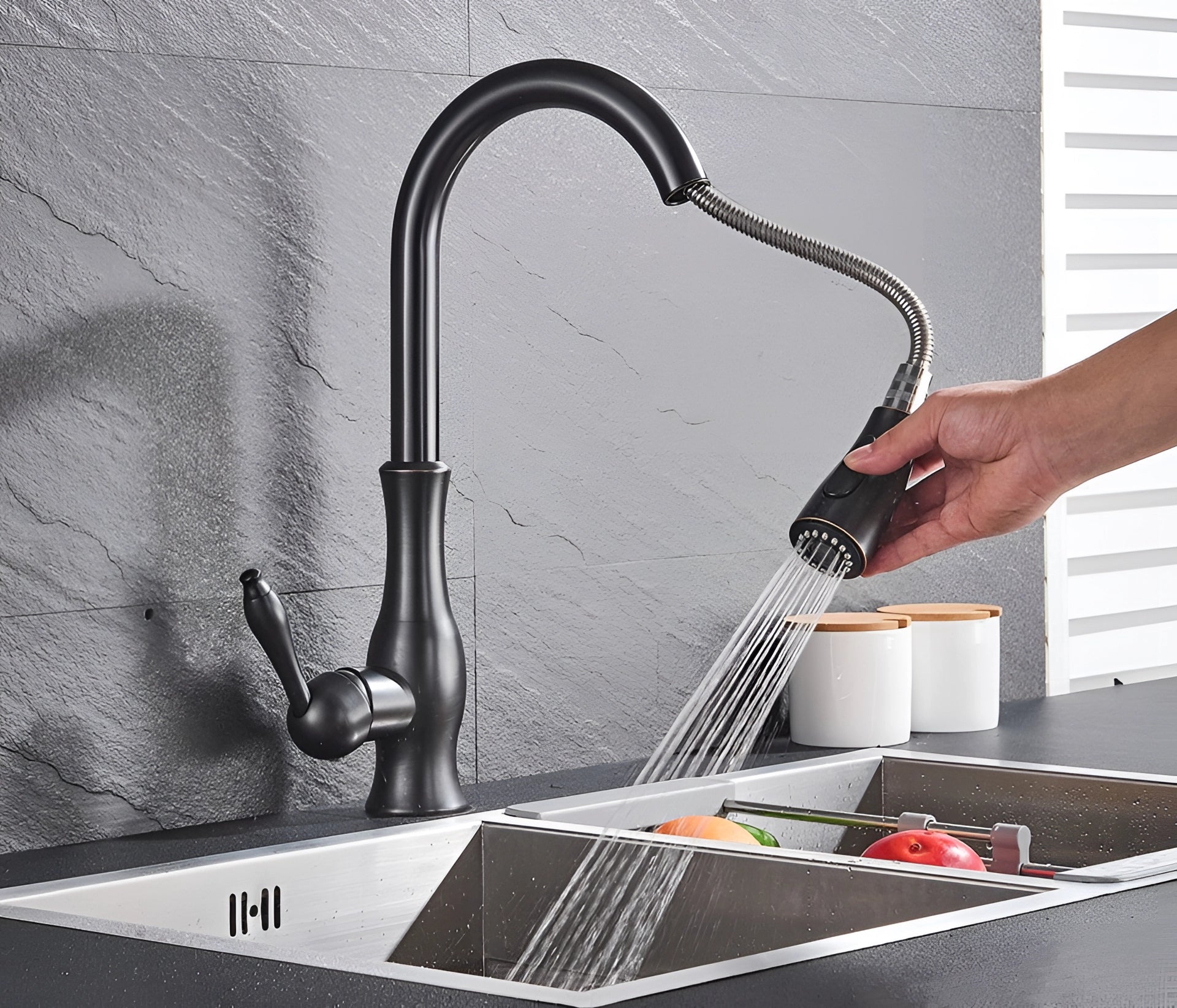 High-arc brushed nickel stainless steel pull-down kitchen faucet installed over a kitchen sink with a modern design.