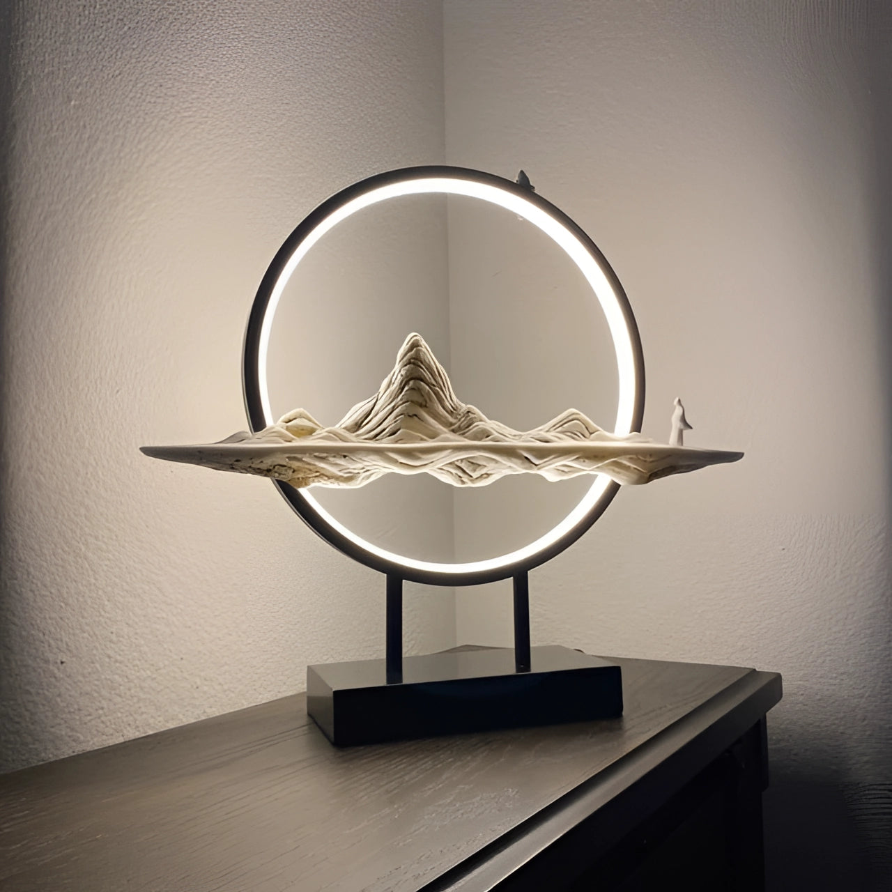 Illuminated circular LED art piece featuring a dynamic smoke and light design with mountain imagery.