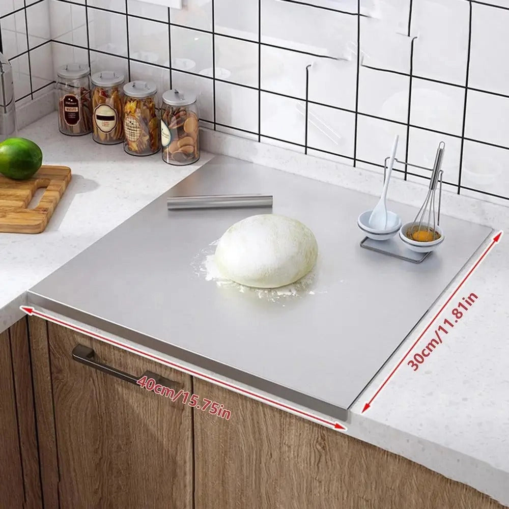 Integrated stainless steel cutting board, rectangular shape, measuring 40x30cm, placed on a kitchen countertop, surrounded by cabinetry and serveware items.